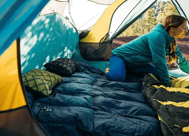 Extra pillows and blankets will pad your sleeping area and make you more comfortable in your tent.