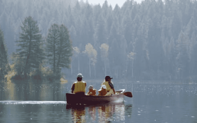 Family With young kids on a canoe