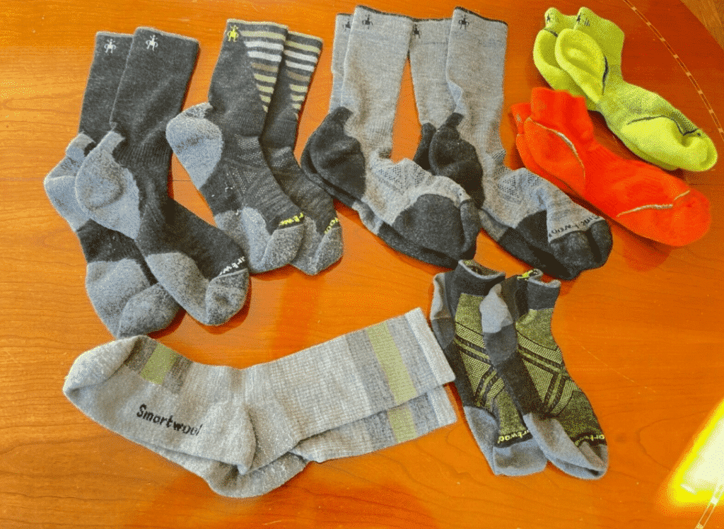 Multiple pairs of smartwool socks in varying styles