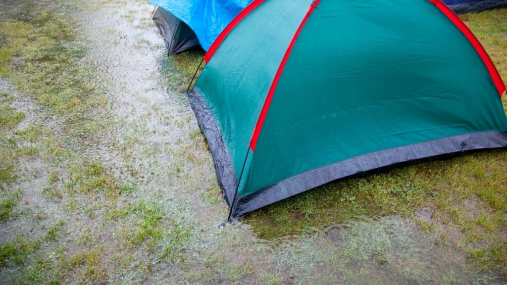 Find a site with good drainage when pitching a tent in the rain.